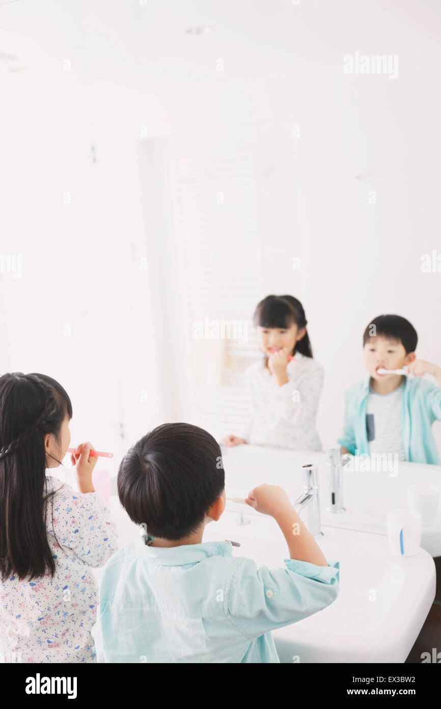 Japanese kid brushing teeth in the bathroom Stock Photo Alamy