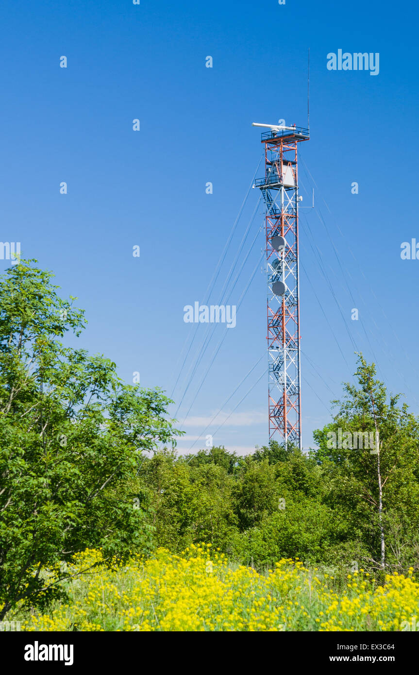 Communication tower on blue sky. Used to transmit radio, tv and mobile signal Stock Photo