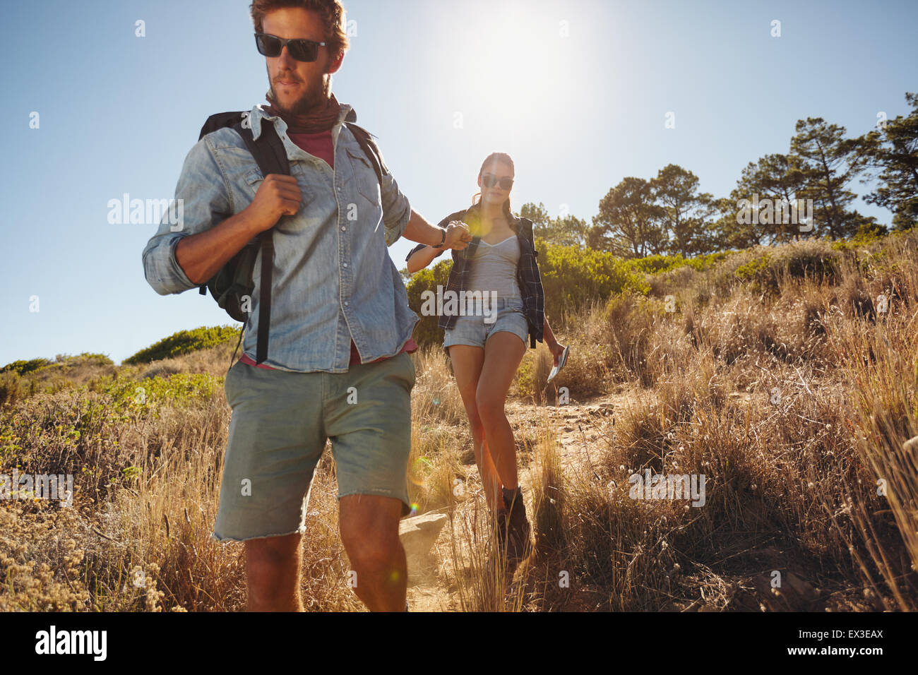 Shot of a young man on a hiking trip with his girlfriend. Young