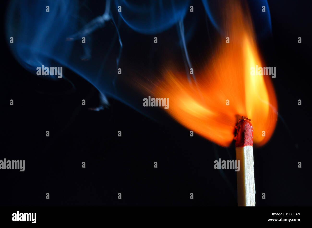 Burning match over black background Stock Photo - Alamy