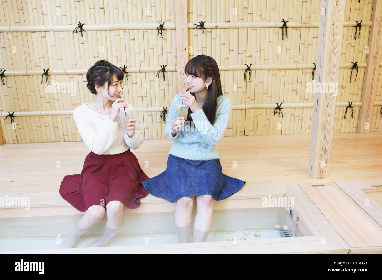 Young Japanese women enjoying foot spa in Kawagoe, Japan Stock Photo