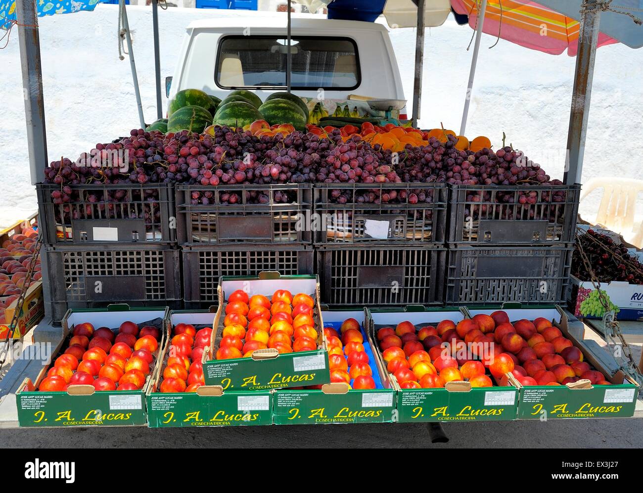 Fresh peaches,grapes and melons being sold from the back of a lorry in Santorini Greece Stock Photo