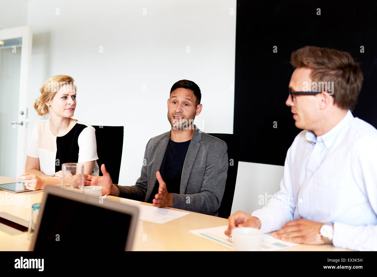 Group of young executives having a meeting in office conference room. Stock Photo