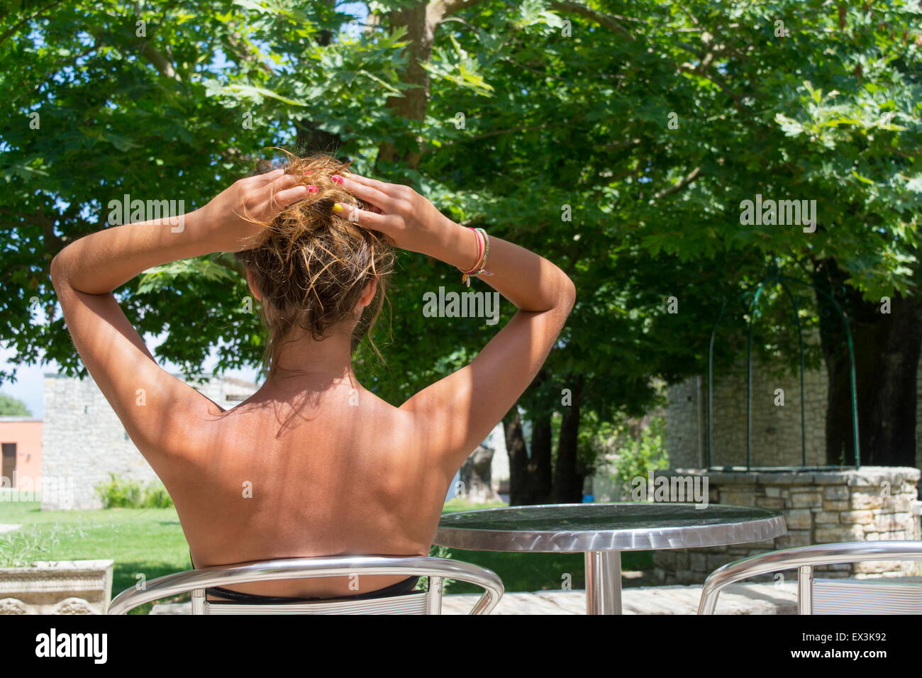 Young Tanned Girl Sitting In A Beautiful Backyard Wearing Bikini With Her Hair Lifted Up Stock Photo Alamy