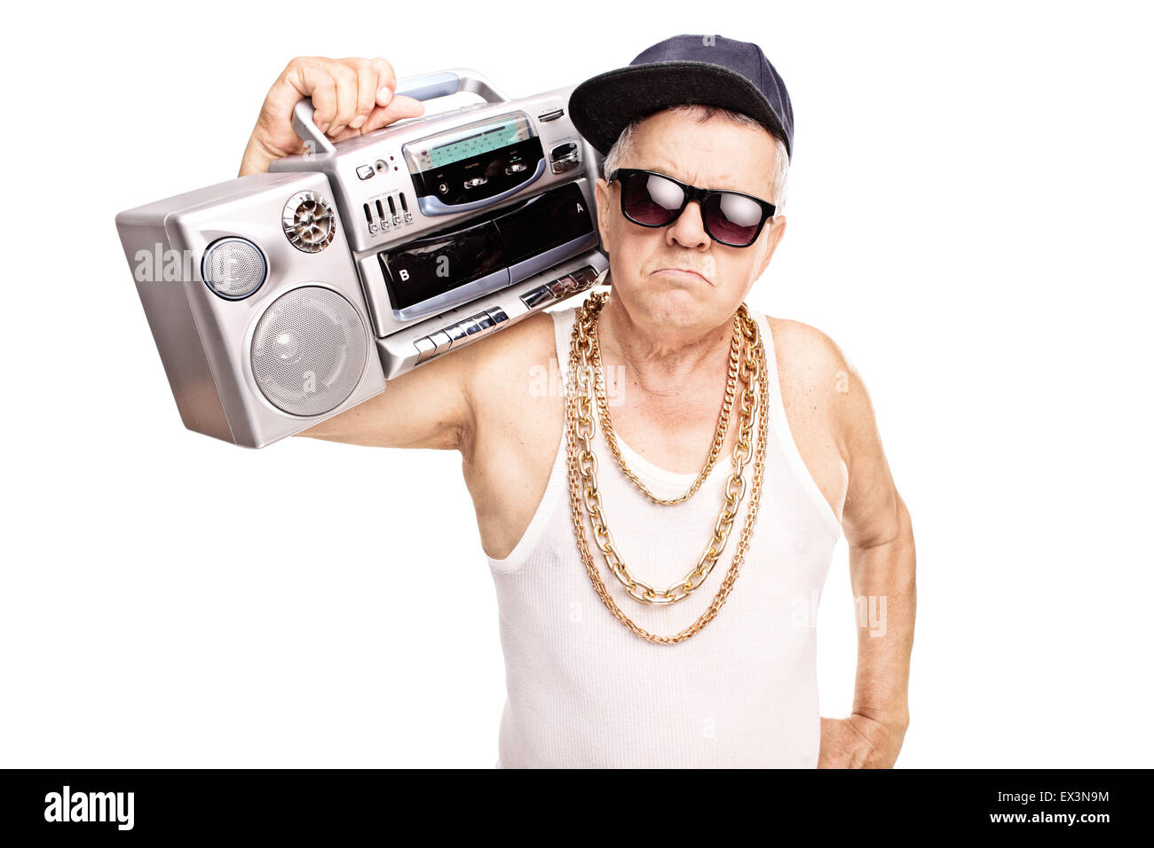 Serious senior rapper holding a ghetto blaster over his shoulder and ...