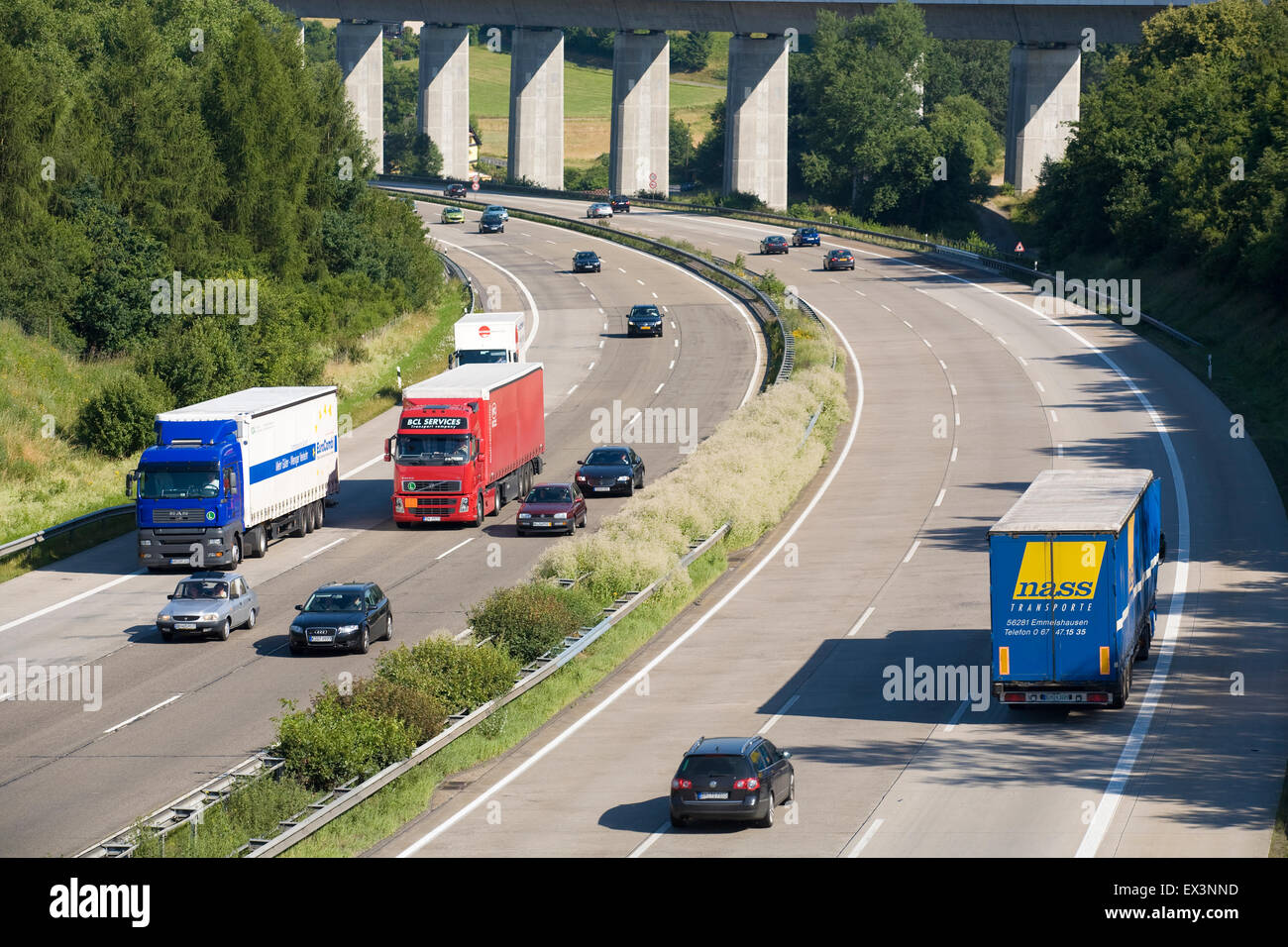 Europe, Germany, Rhineland-Palatinate, trucks at a climb of the Autobahn A3 near Neustadt Wied, Hallerbachtal bridge of the rail Stock Photo