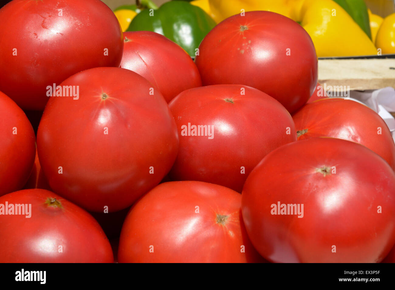 lot of ripe tomatoes in wooden crates close up Stock Photo