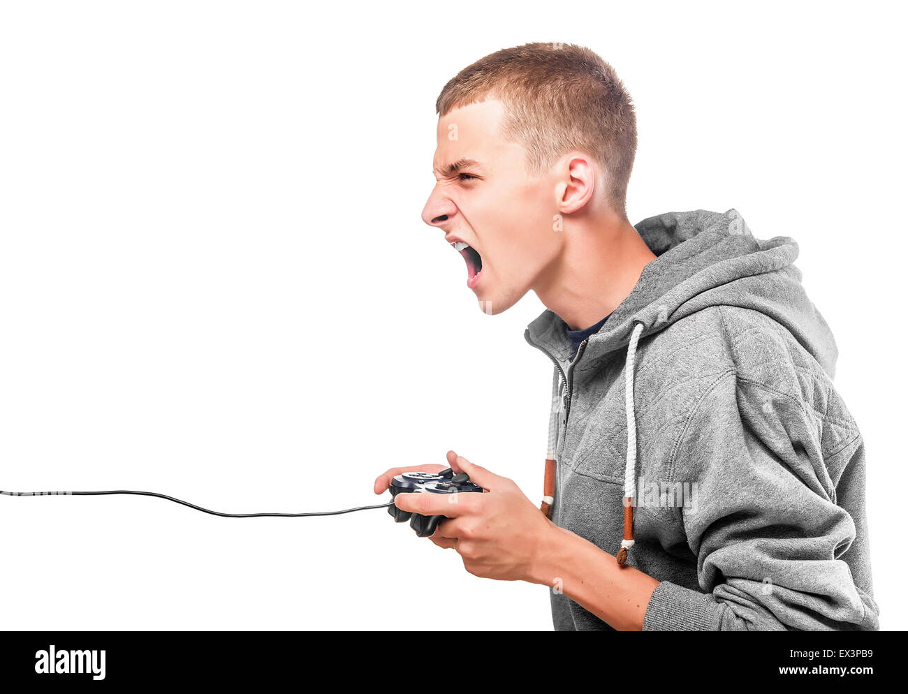 Young man with a joystick for game console side view. Isolated on white. Stock Photo