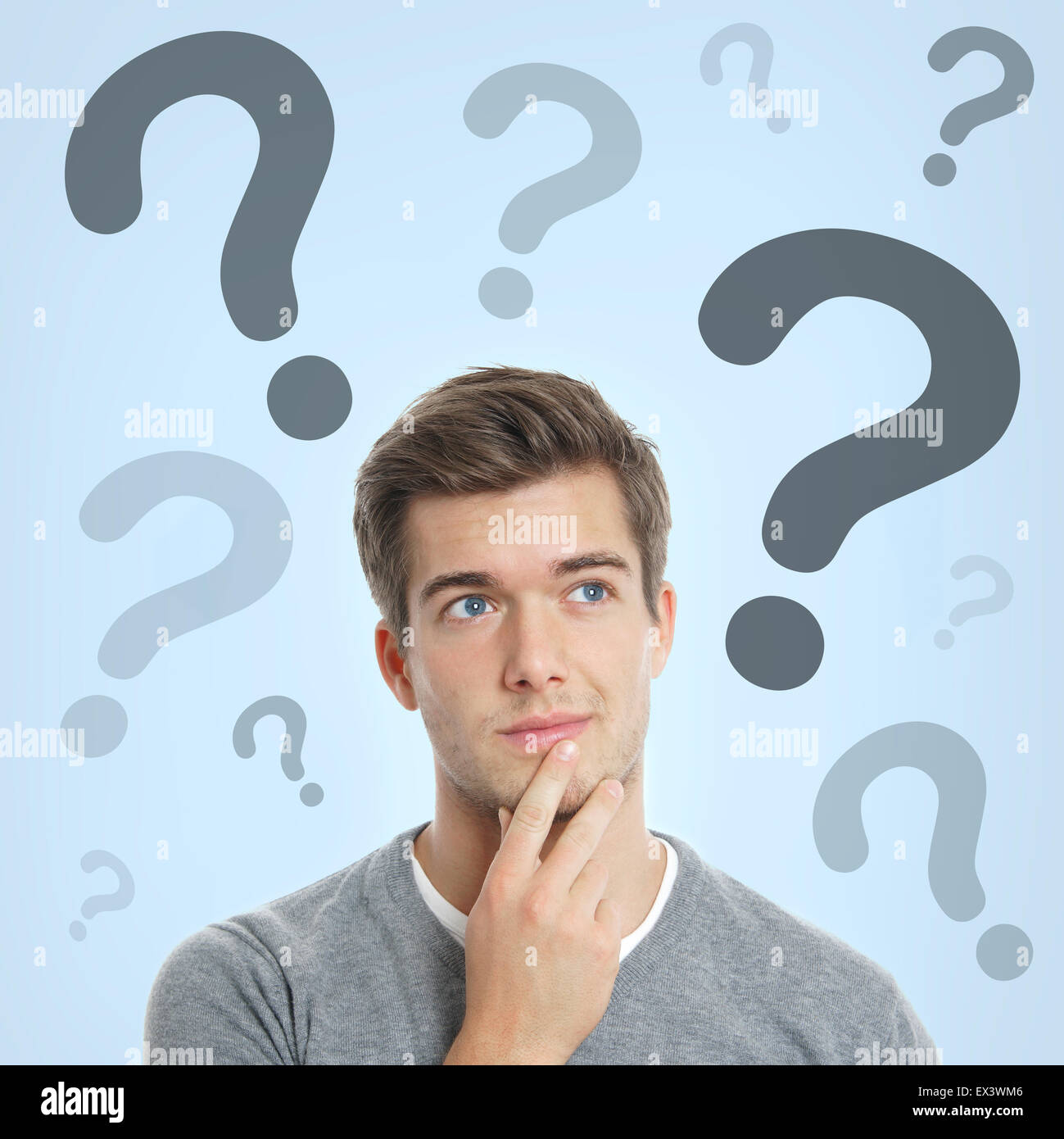 young man with question marks Stock Photo