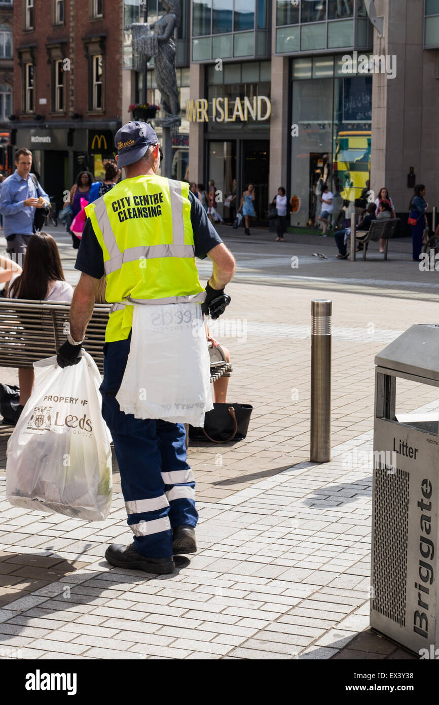 Worker from Leeds City Council City Centre Cleansing Team emptying bins