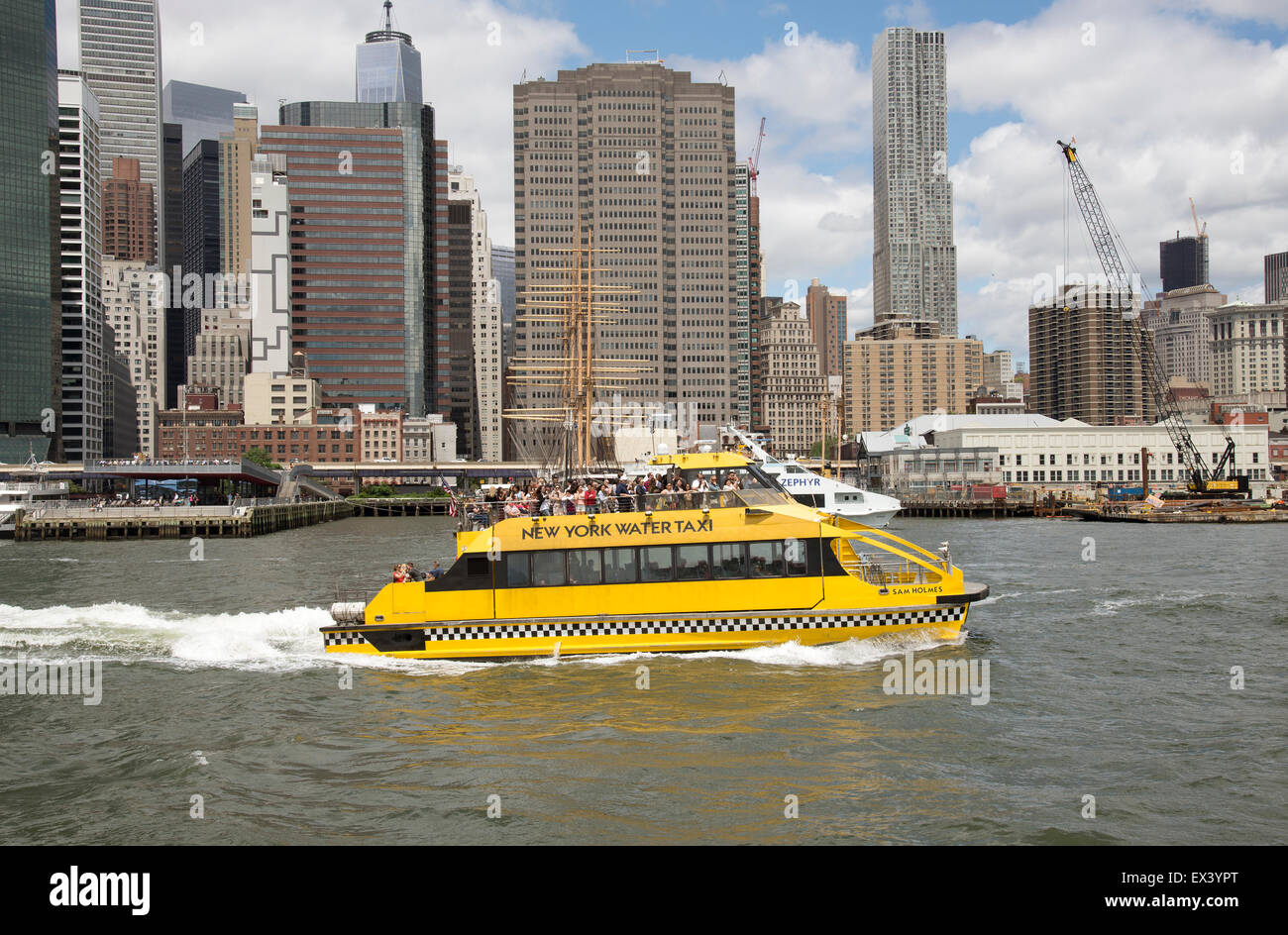 Passengers aboard a New York water taxis pass the Manhattan skyline NYC USA Stock Photo