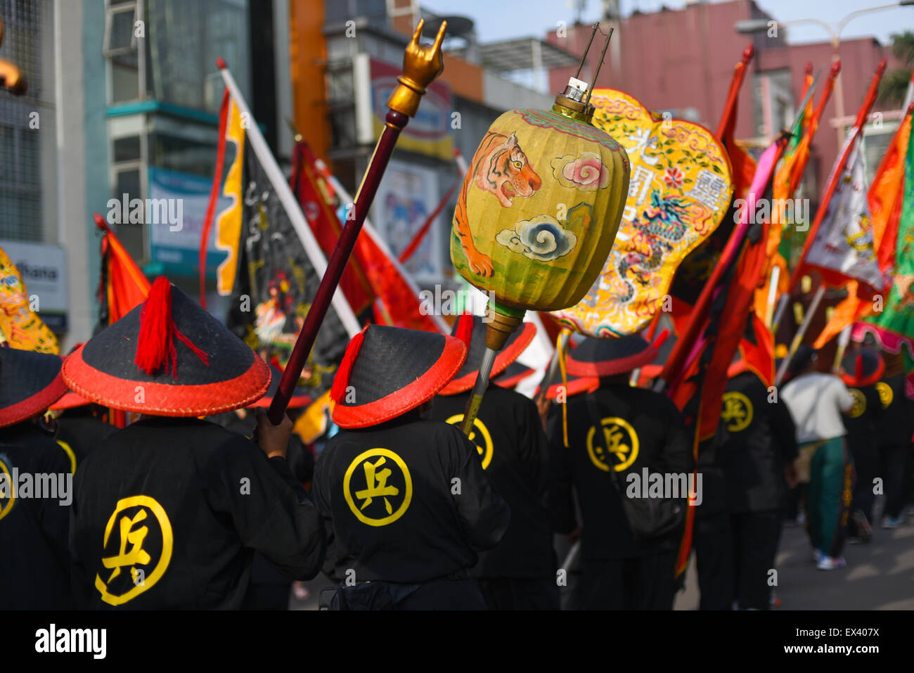 People in Chinese ethnic clothings and symbols during the 2015 Bandung Lantern Festival Cultural Parade (Kirab Budaya Cap Go Meh Bandung 2015). Stock Photo