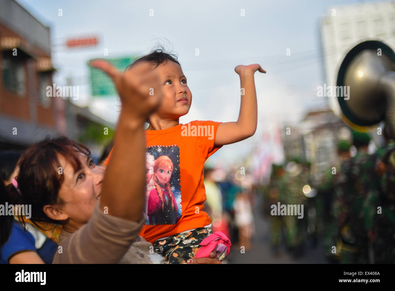 Young girl cheering street parade. Stock Photo