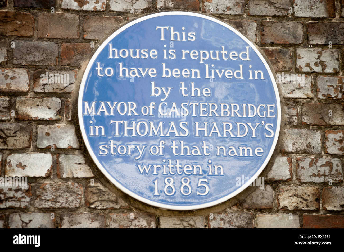 Plaque identifying location of the fictional Mayor of Casterbridge's house on a wall  in Dorchester, Dorset, England, UK. Stock Photo