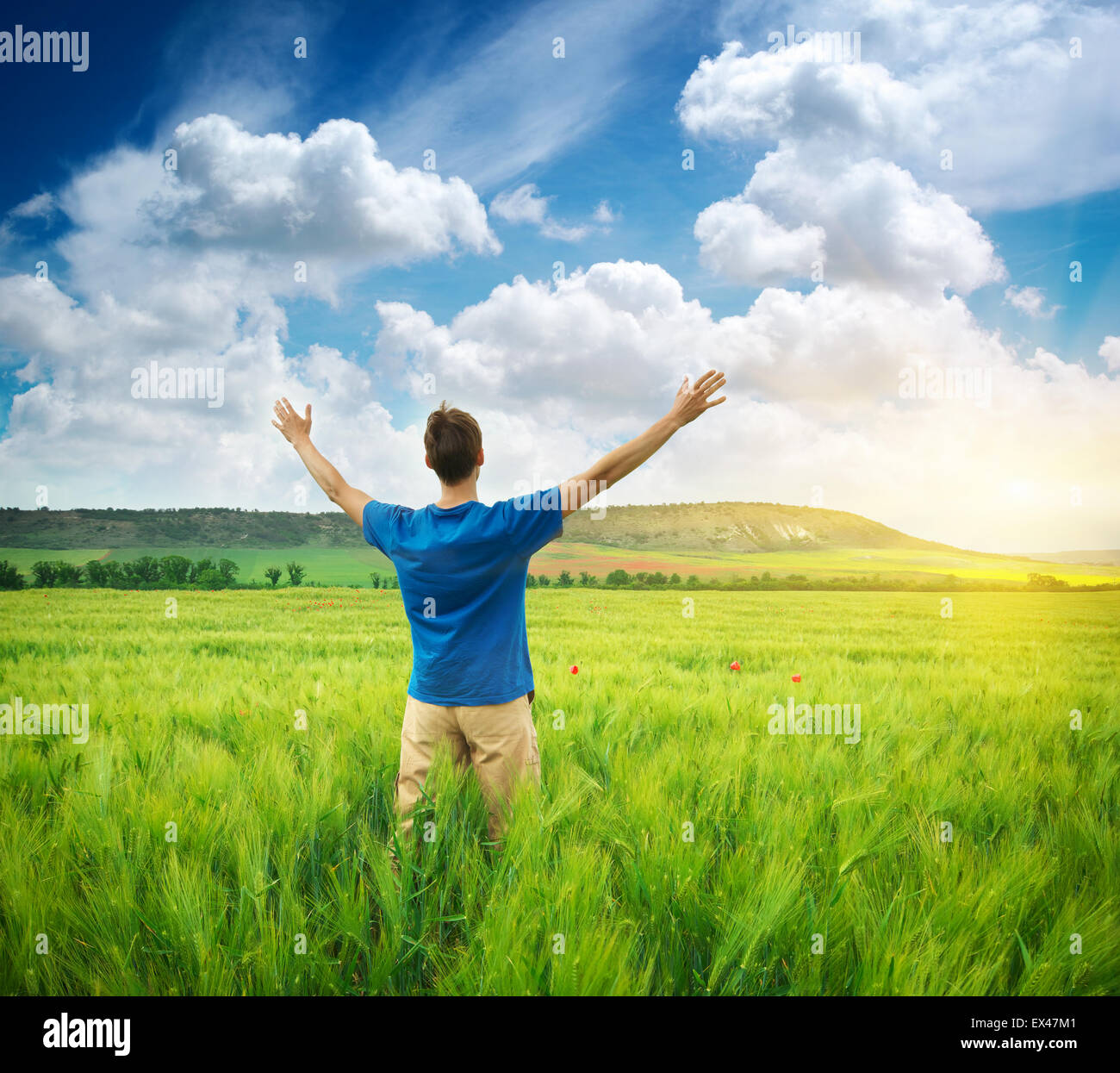 Man in green meadow. Emotional scene. Stock Photo