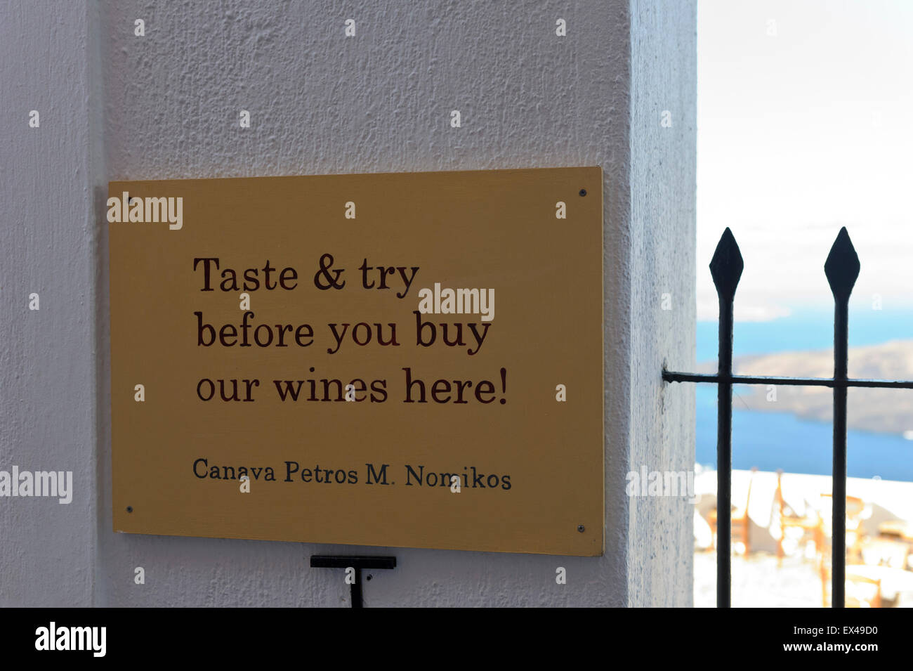 A sign with a statement by Canava Petros Nomikos outside a restaurant in Santorini, Greece. Stock Photo