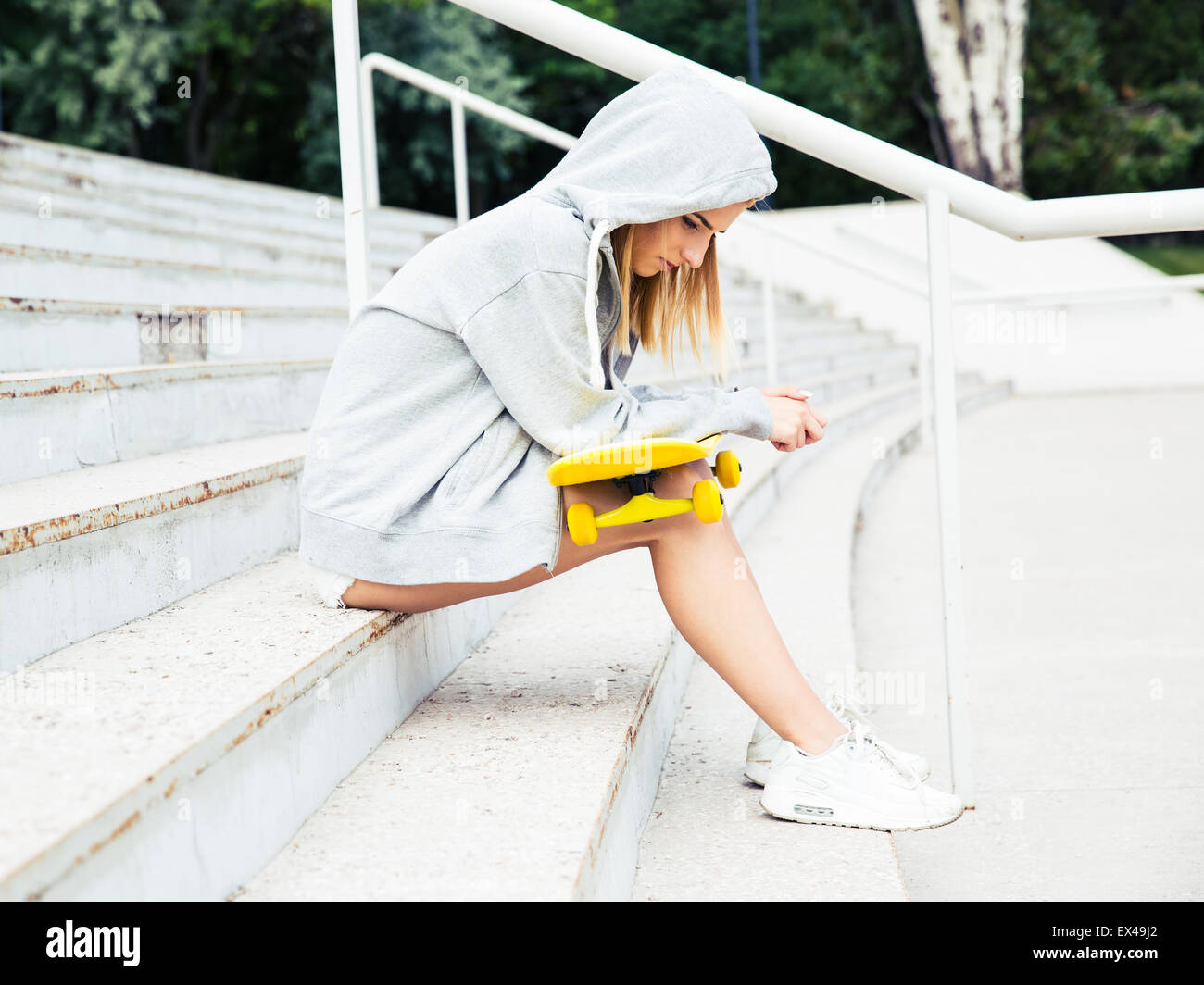 Sad girl sitting on stairs hi-res stock photography and images - Alamy