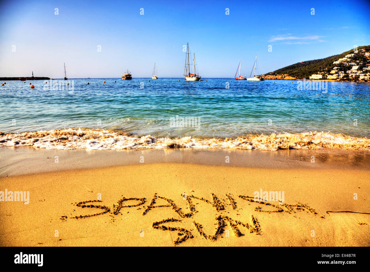 Spanish sun Spain words in sand written on beach holiday holidays vacation vacations resort seas coast coastlines Ibiza Stock Photo