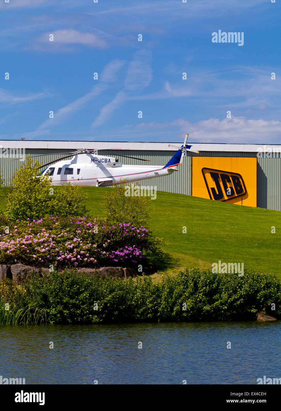 Private helicopter outside JCB World Headquarters in Rocester Staffordshire England UK a manufacturer of construction equipment Stock Photo