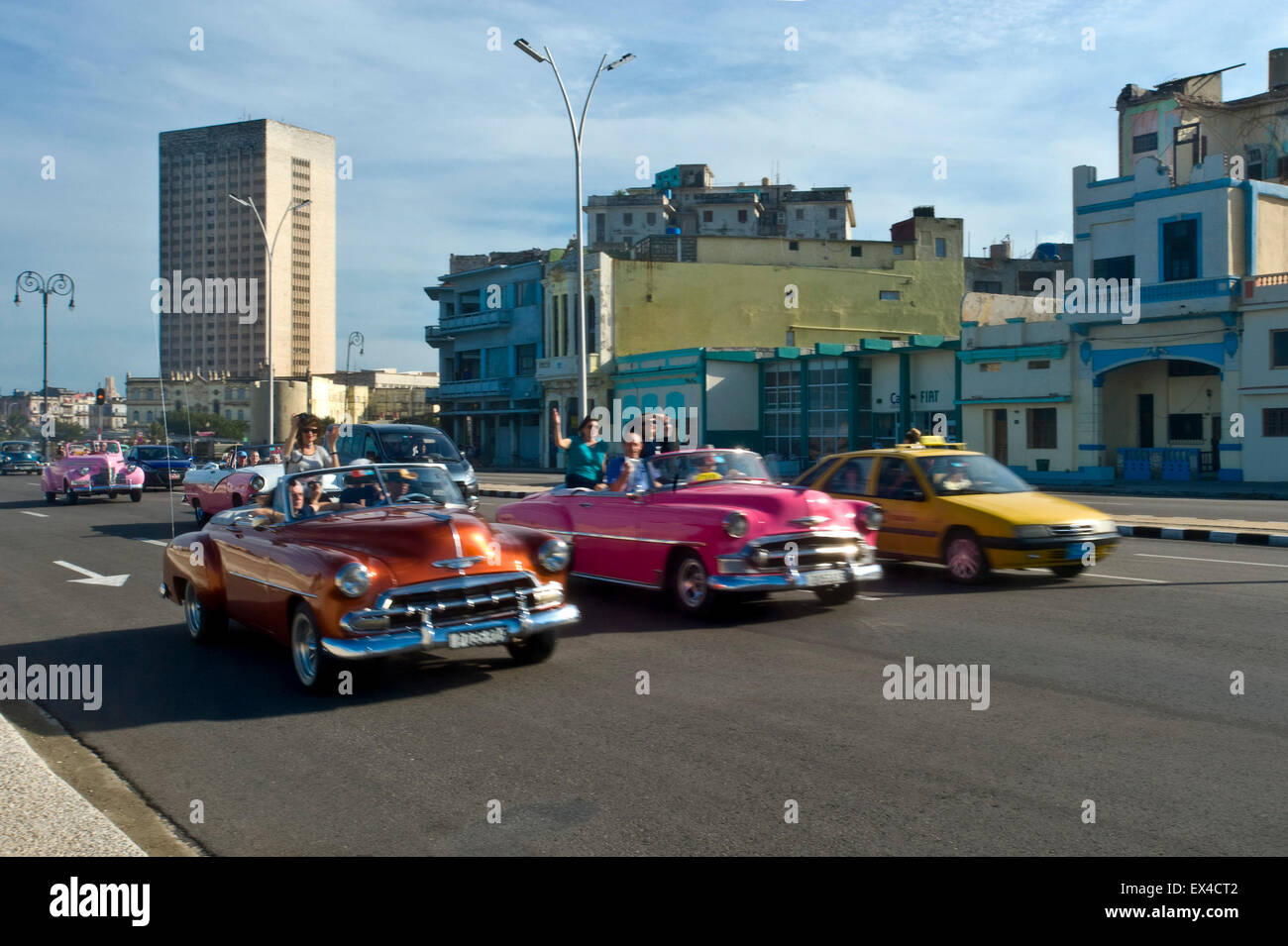 Horizontal view of classic old American cars driving along the Malecon in Havana, Cuba. Stock Photo