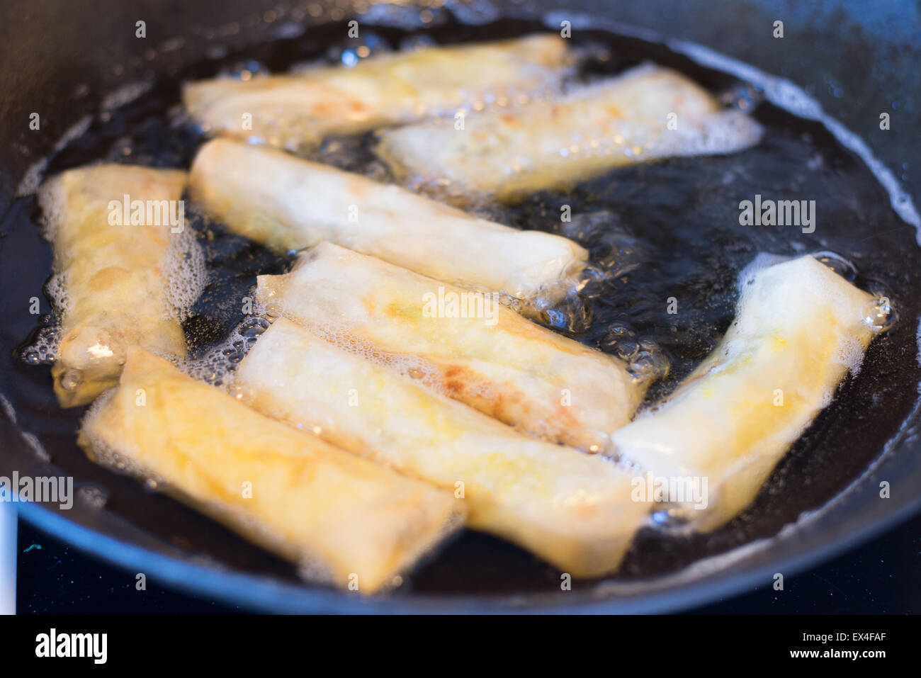 Frying spring rolls in oil Stock Photo Alamy