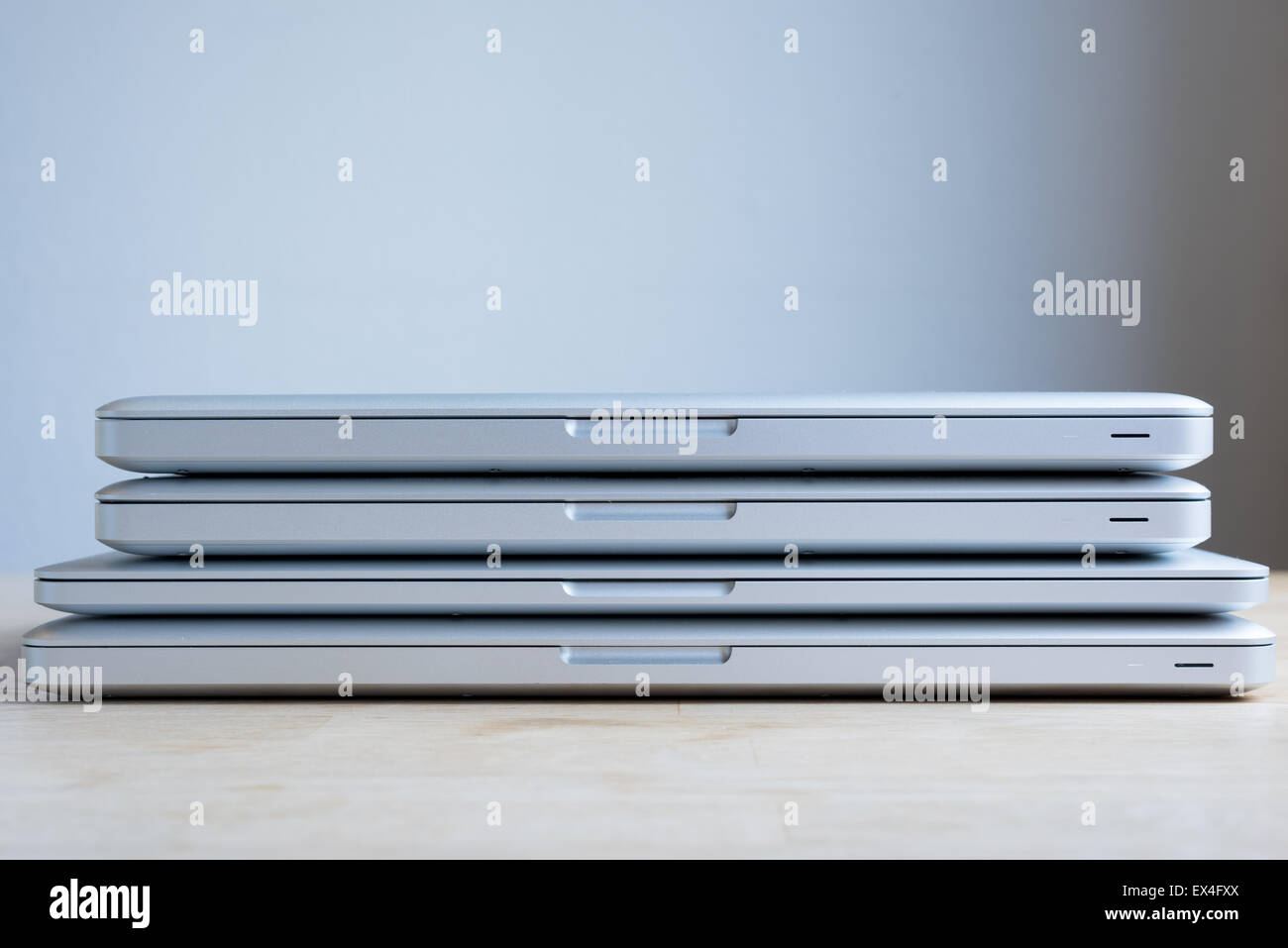 A bunch of aluminium laptops stacked on top of each other. Stock Photo