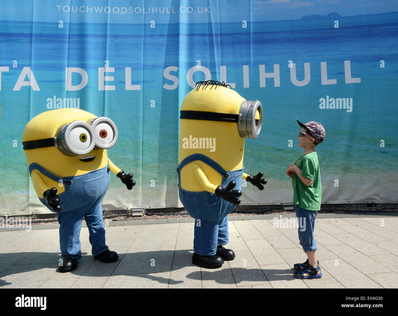 Child boy meets interacts with the Minions at Touchwood Shopping Centre Stock Photo