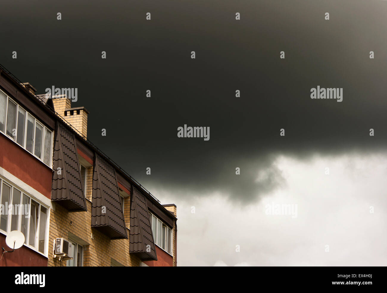 dark storm cloud over the roof of the house on spring day Stock Photo ...