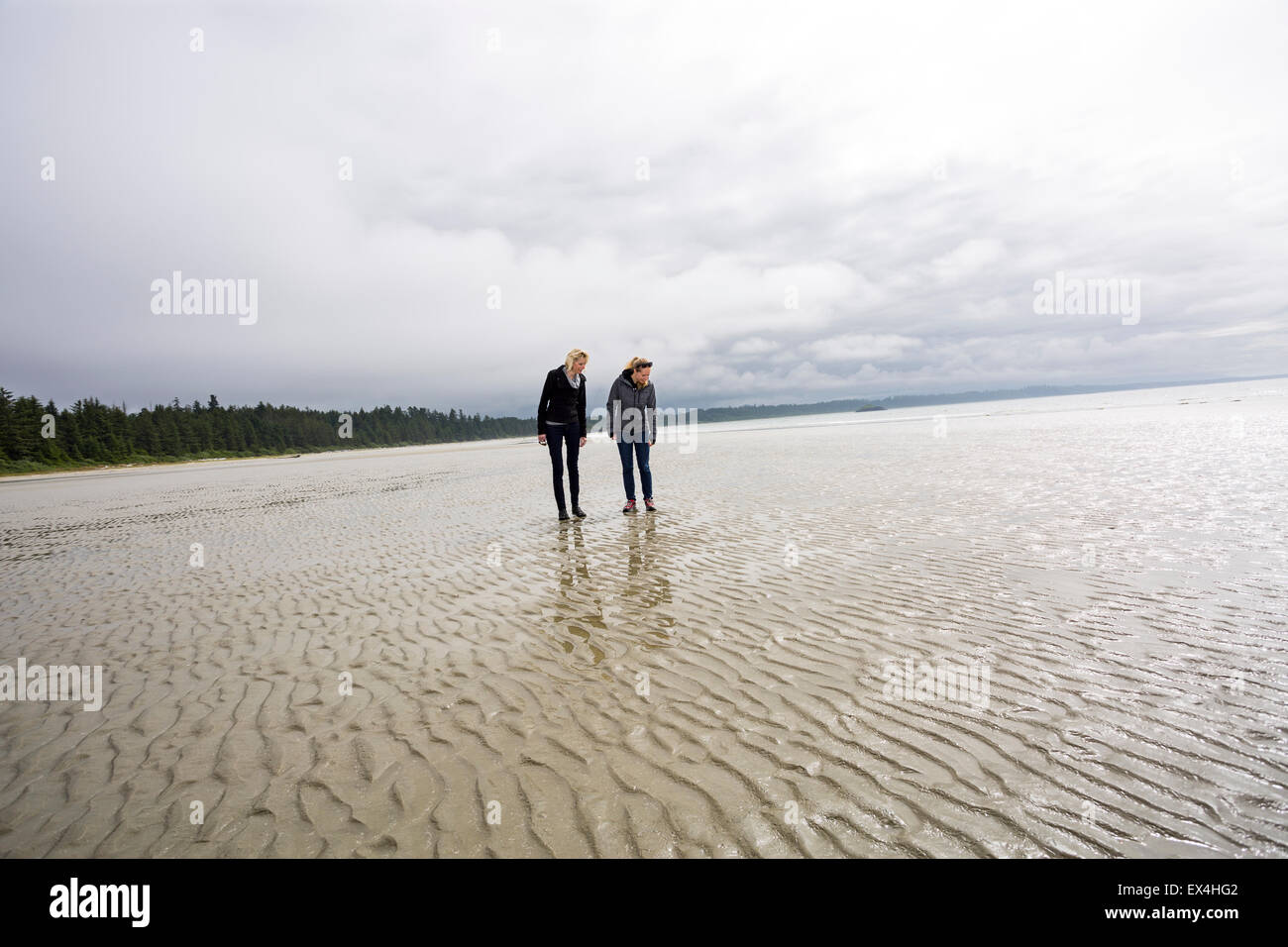 Canada, British Columbia, Vancouver Island, Pacific Ocean, Pacific Rim National Park Reserve, 2 women looking for seashells Stock Photo