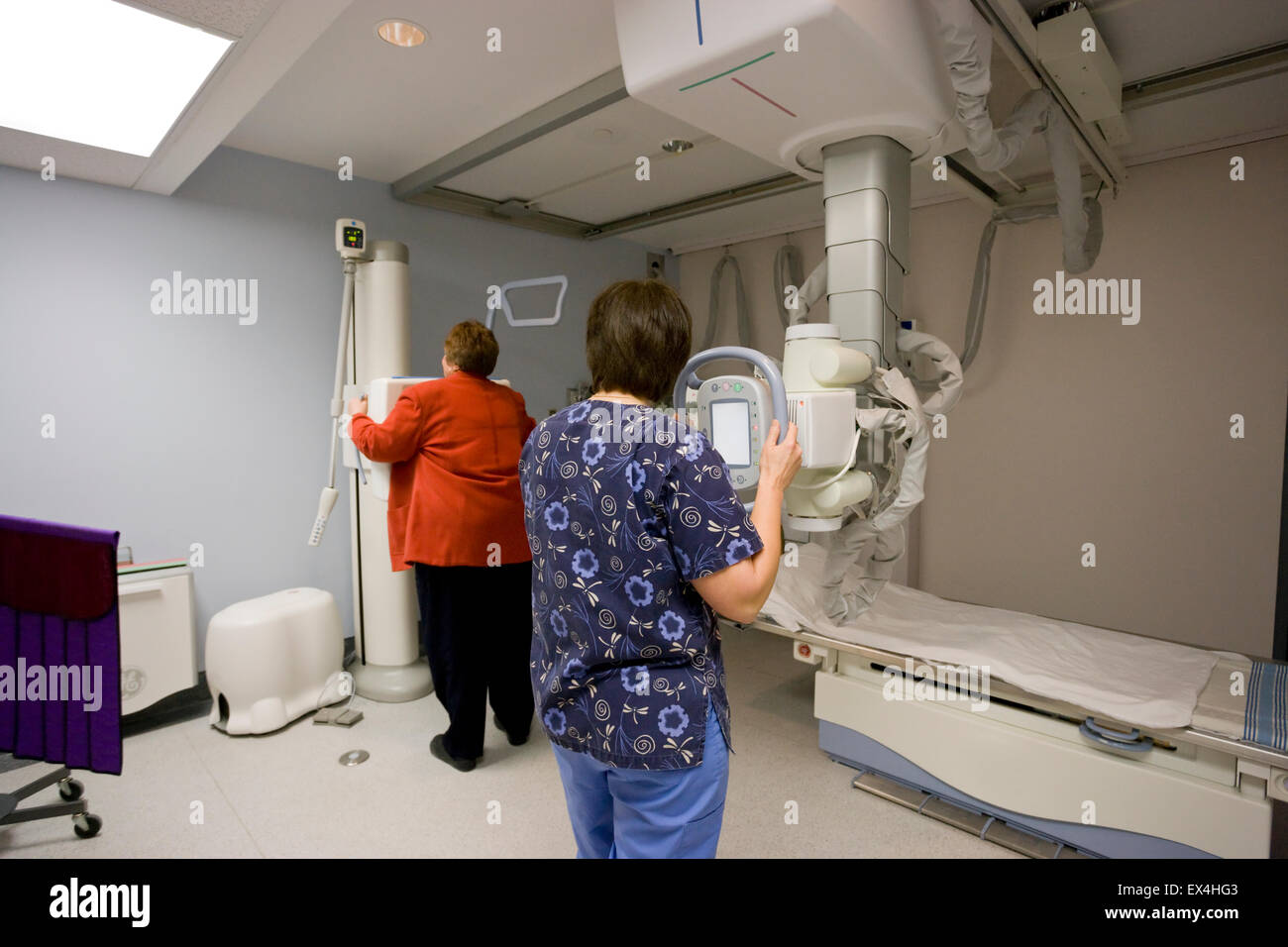 radiologist  with digital X Ray machine - patient receiving chest X Ray Stock Photo