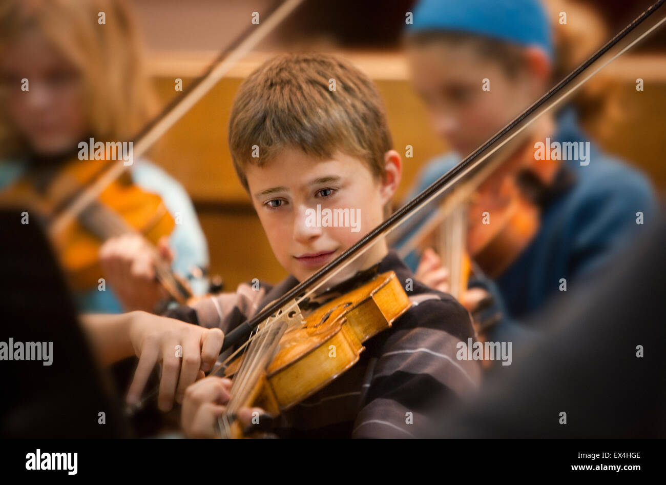 boy playing viola in orchestra Stock Photo
