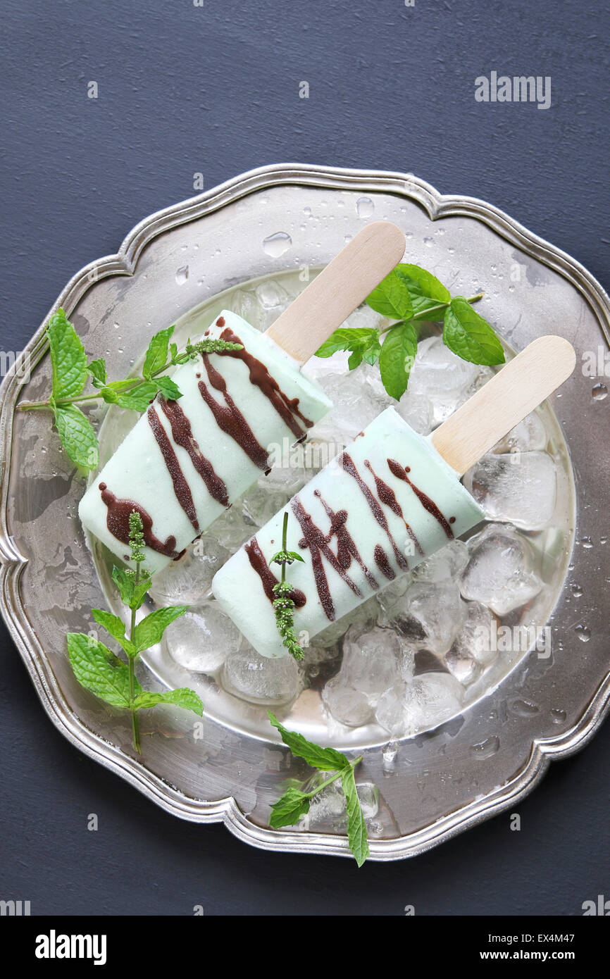 Ice cream mint popsicles drizzled with chocolate Stock Photo