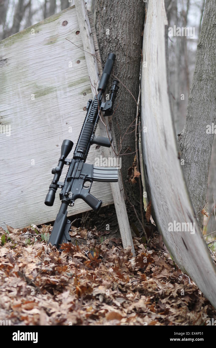 Airsoft gun leaning against a tree Stock Photo Alamy