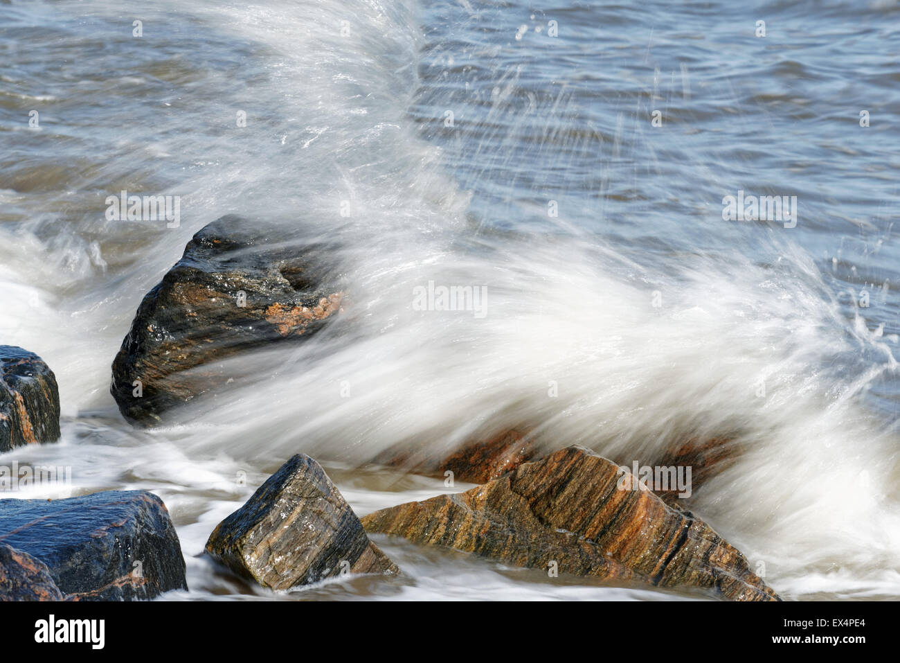 Waves splashing on rocks Stock Photo