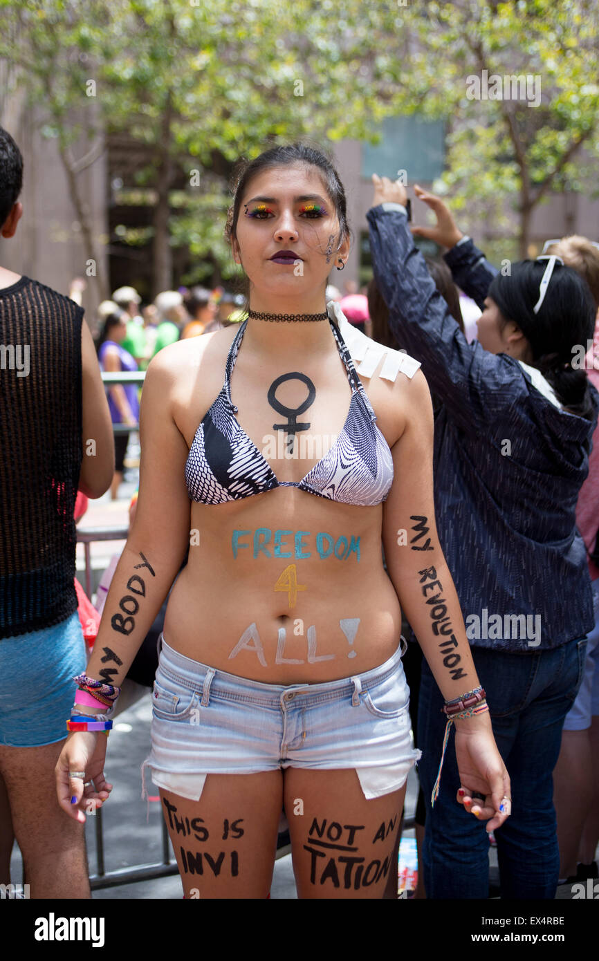 Ligia from Brazil attended the San Francisco Pride Parade with statements including 'my body my revolution' written on her body. Stock Photo