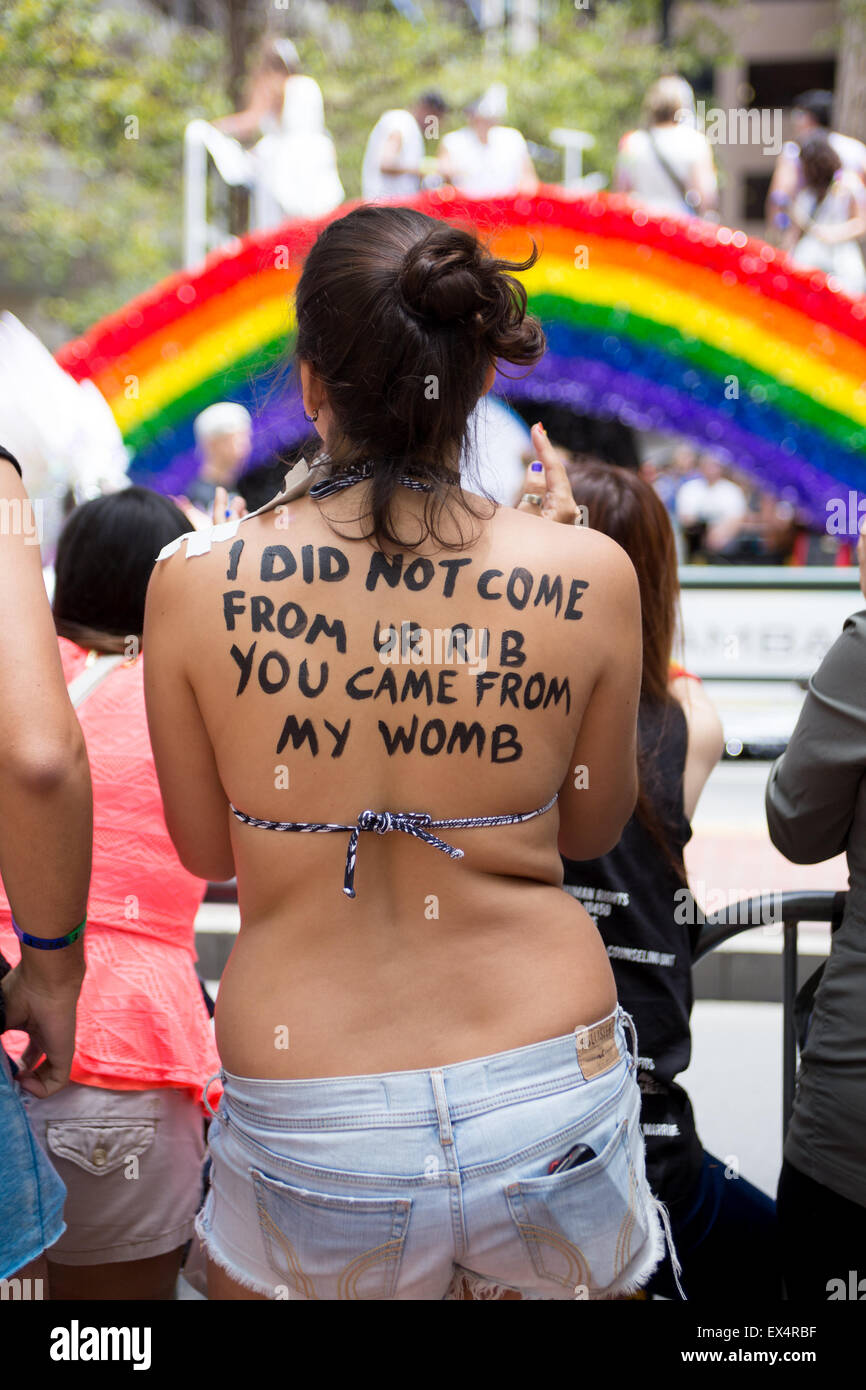 Ligia from Brazil attended the San Francisco Pride Parade with statements written on her body. Stock Photo