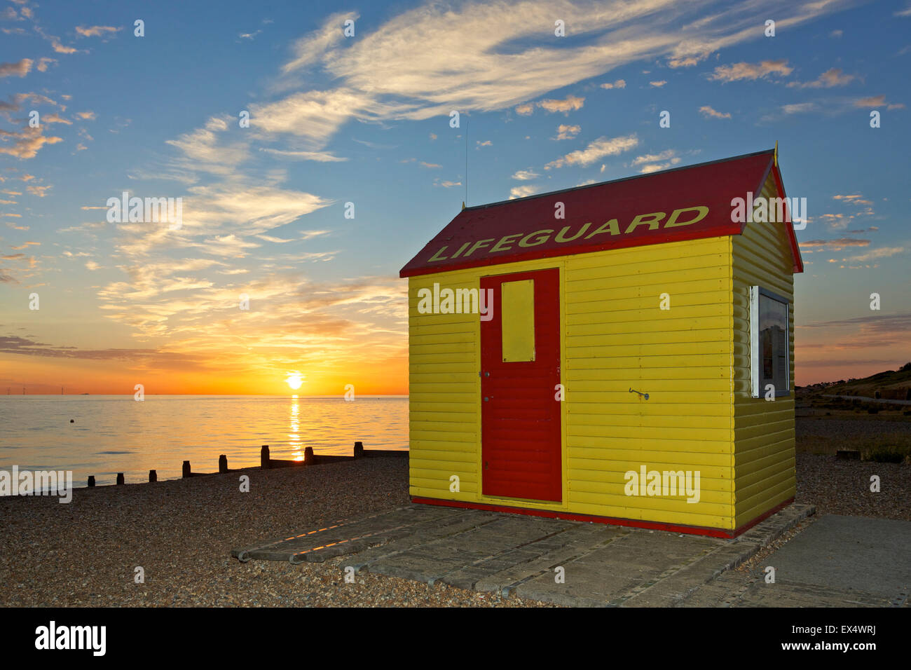 Tankerton, Kent, UK. 7th July 2015: UK Weather. Sunrise at Tankerton beach near Whitstable in Kent at high tide. Temperatures are forecast to stay in the early 20's for the next few days with some showers Credit:  Alan Payton/Alamy Live News Stock Photo