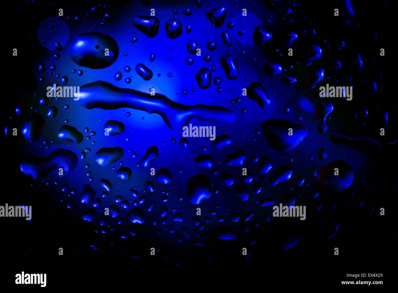 blue abstract background with water drops on glass for background or ...