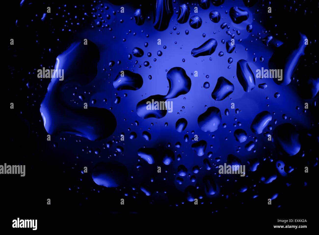 blue abstract background with water drops on glass for background or ...