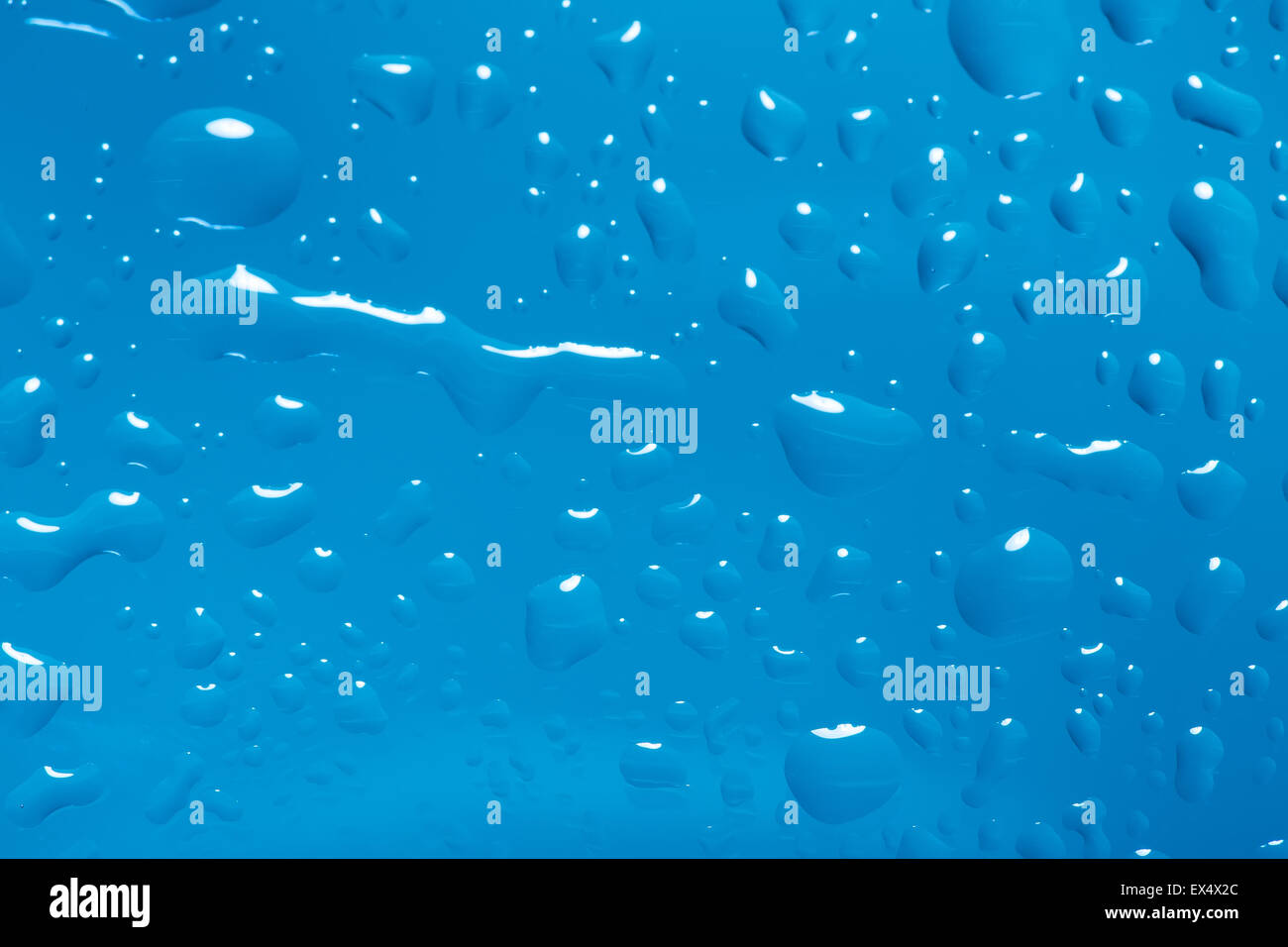 blue abstract background with water drops on glass for background or ...