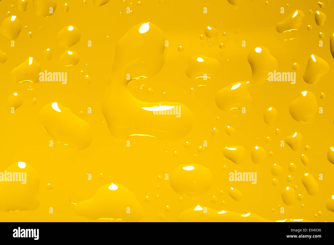 yellow abstract background with water drops on glass for background or ...