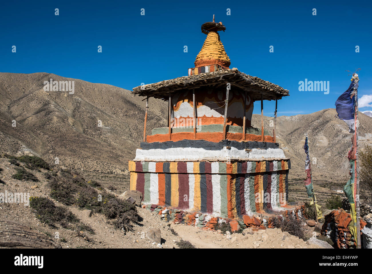 Colourfully painted Buddhist stupa in front of mountain landscape, Samar, Mustang, Nepal Stock Photo