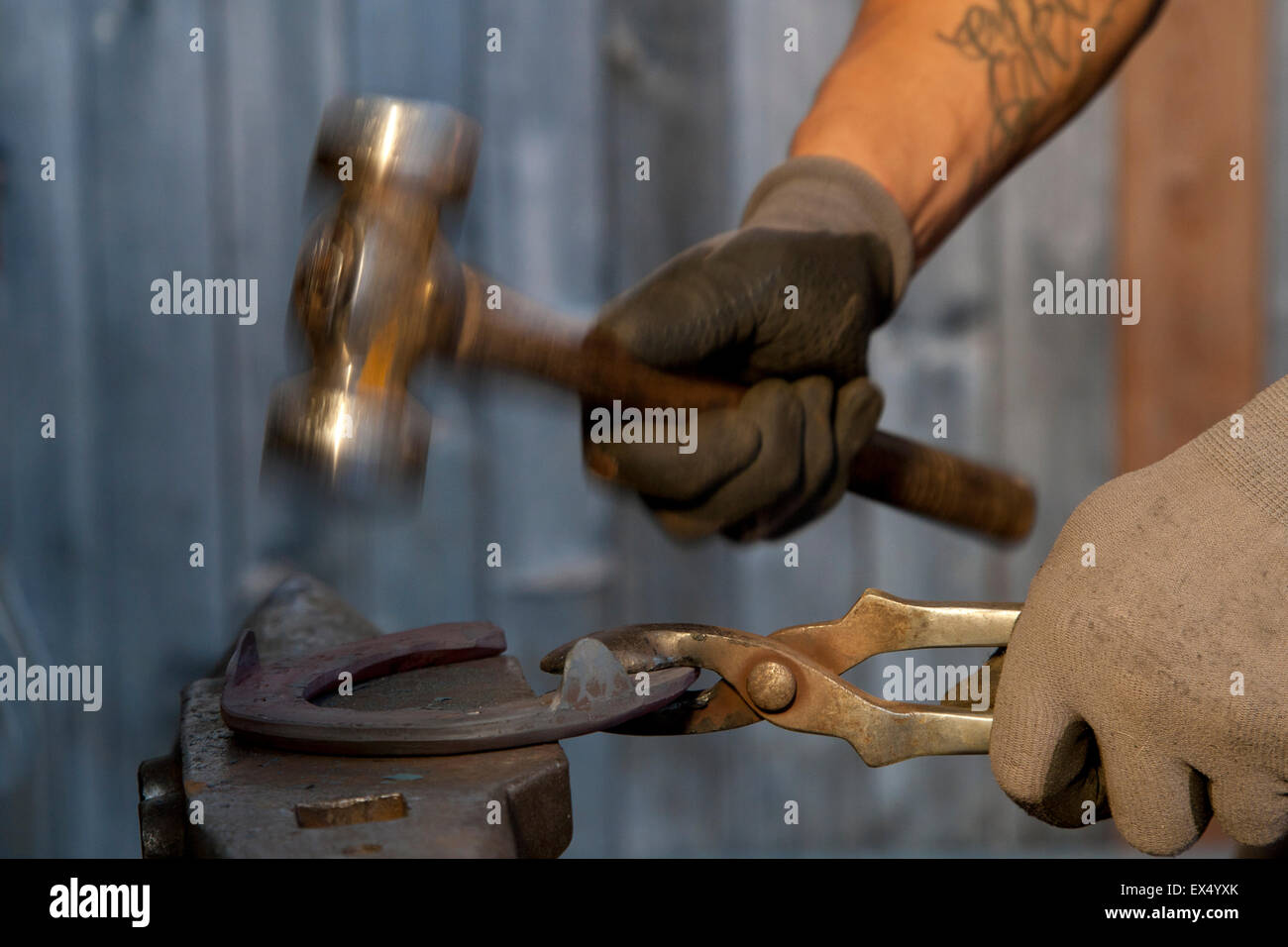 Blacksmith hands shaping horseshoe with hammer, Gschnitztal Valley, Tyrol, Austria Stock Photo