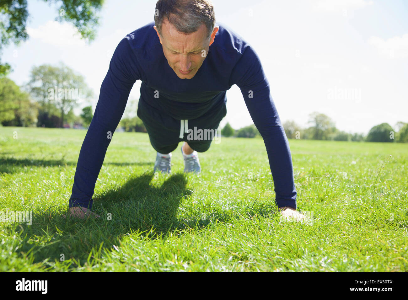 Mature Man doing Pushups in the Park Stock Photo