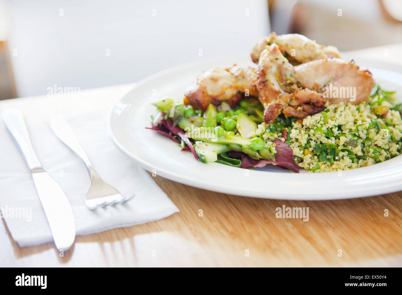 Thyme Roast Chicken with Quinoa Salad Asparagus and Peas Stock Photo