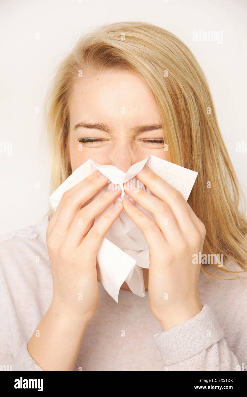 Young Woman Blowing her Nose Sneezing Stock Photo