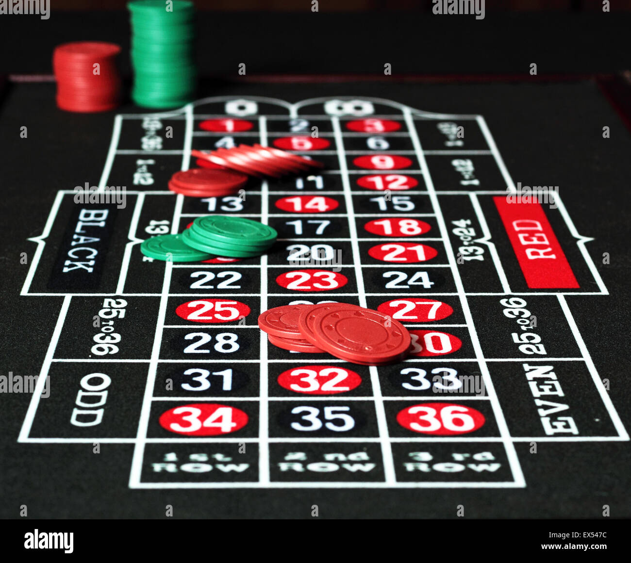 Red and green jetons placed on a roulette table Stock Photo Alamy