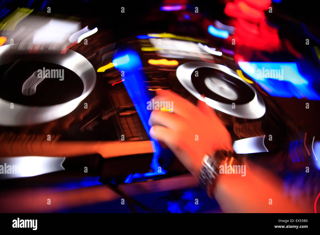 Colourful motionblur image of a DJ hand making mysic on the decks / sound  mixing devices. Athens nightclub, Greece Stock Photo - Alamy