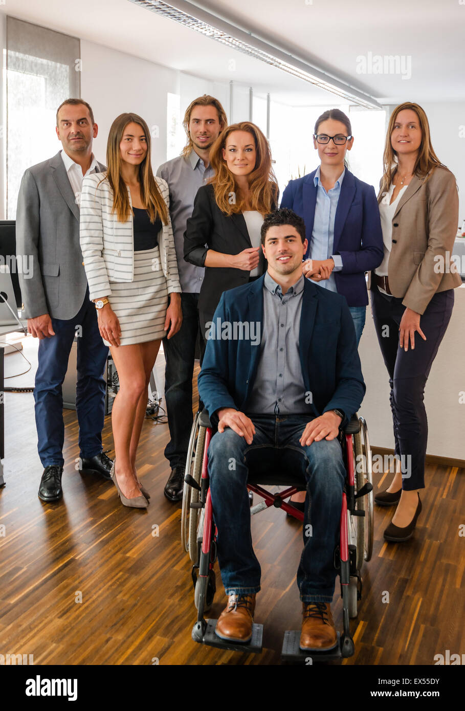 Portrait Of Business Team With Wheelchair Stock Photo