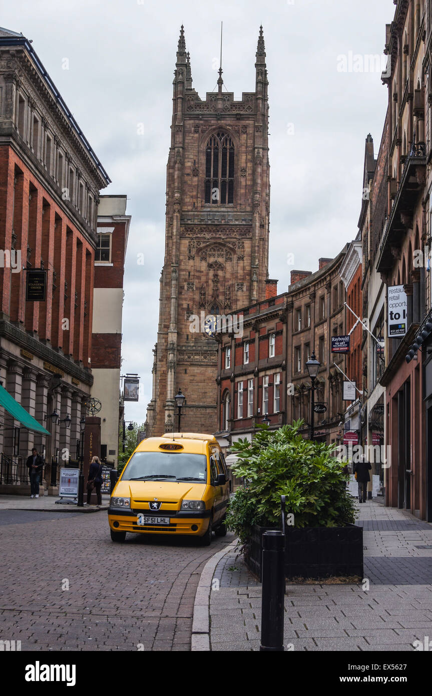A disabled access taxi, Irongate, Derby, Derbyshire, England with a view of the Cathedral Stock Photo